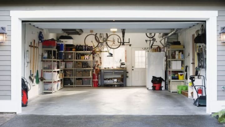 a garage is organized with shelving to allow for a car