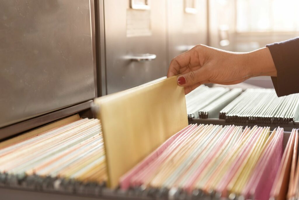 Documents in files placed in an organized filing cabinet.
