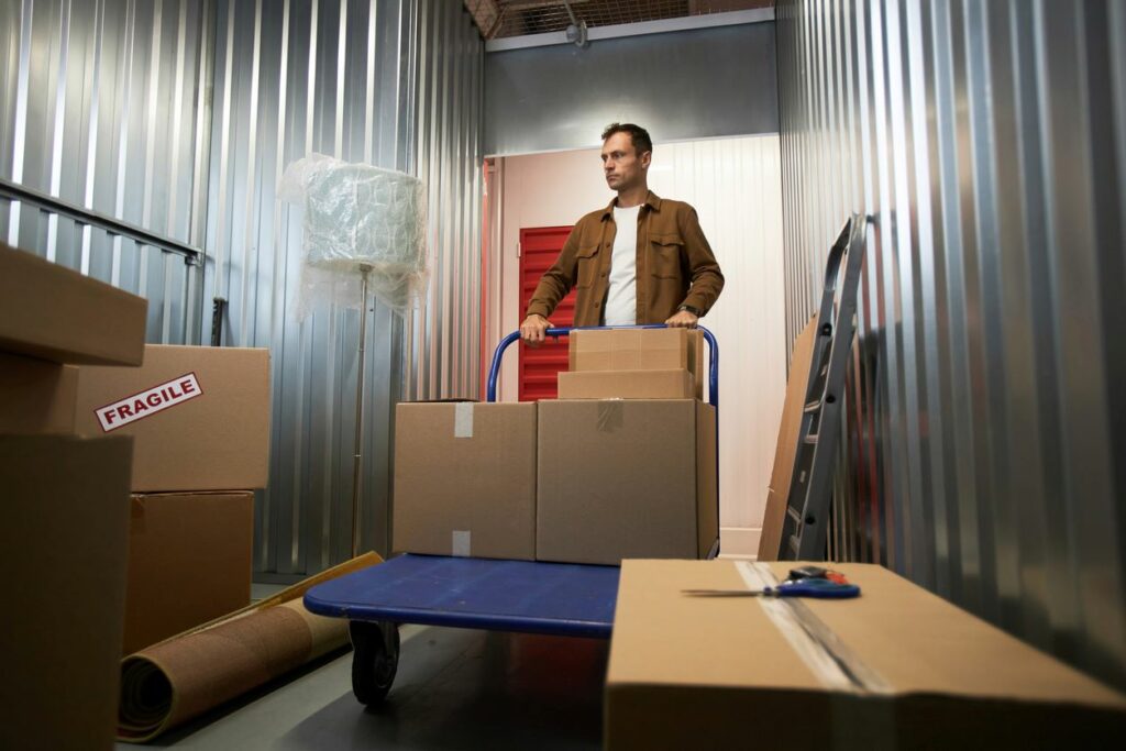 A man loads boxes into his self storage unit as he relocates homes.