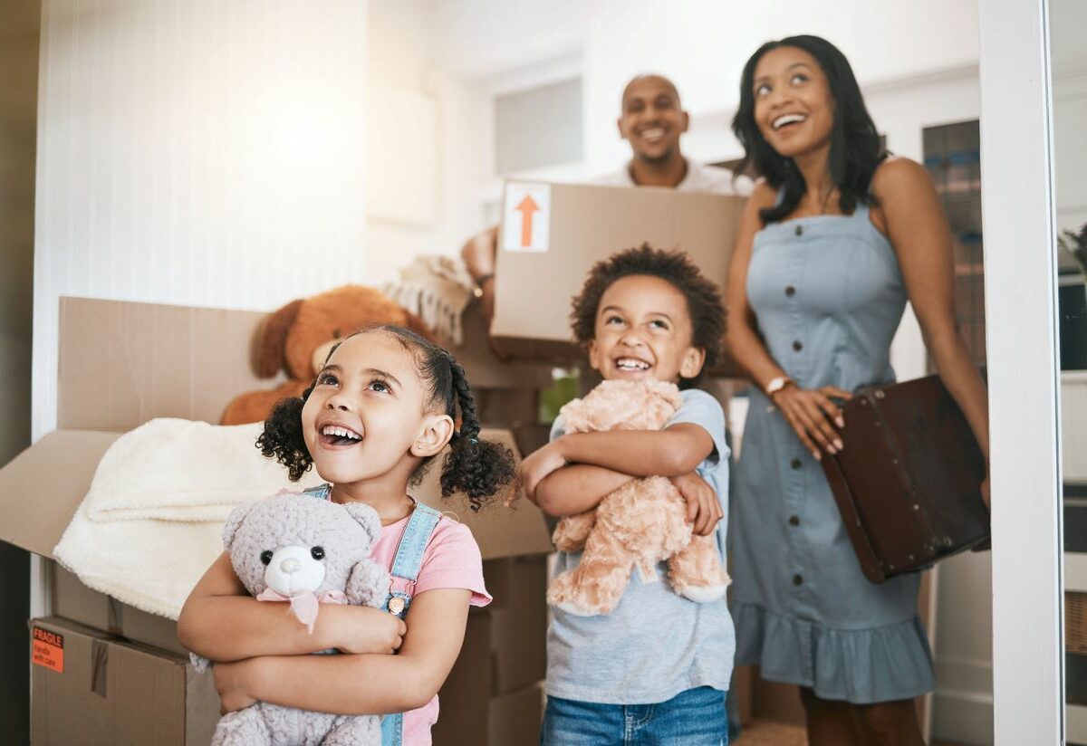 A family walking into their new house.