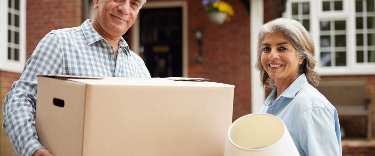 An empty-nester couple moves things out of their home while downsizing.