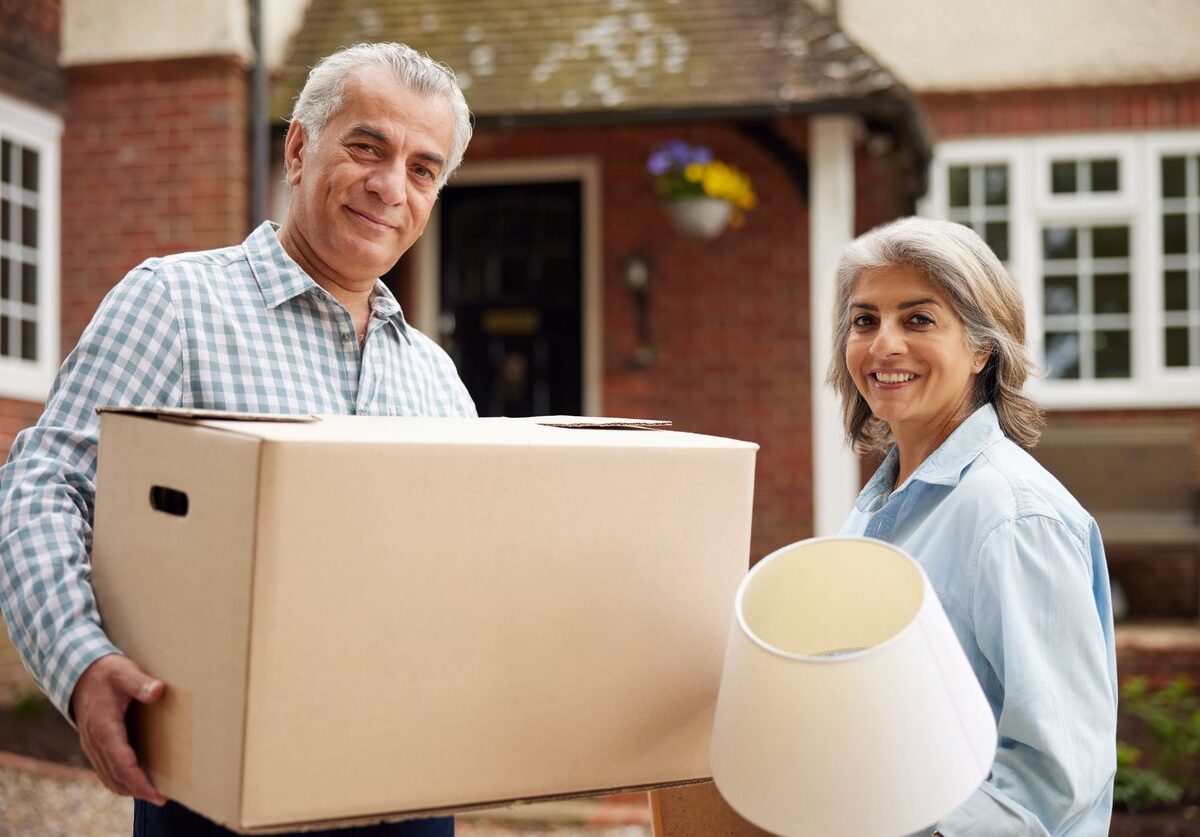 An empty-nester couple moves things out of their home while downsizing.