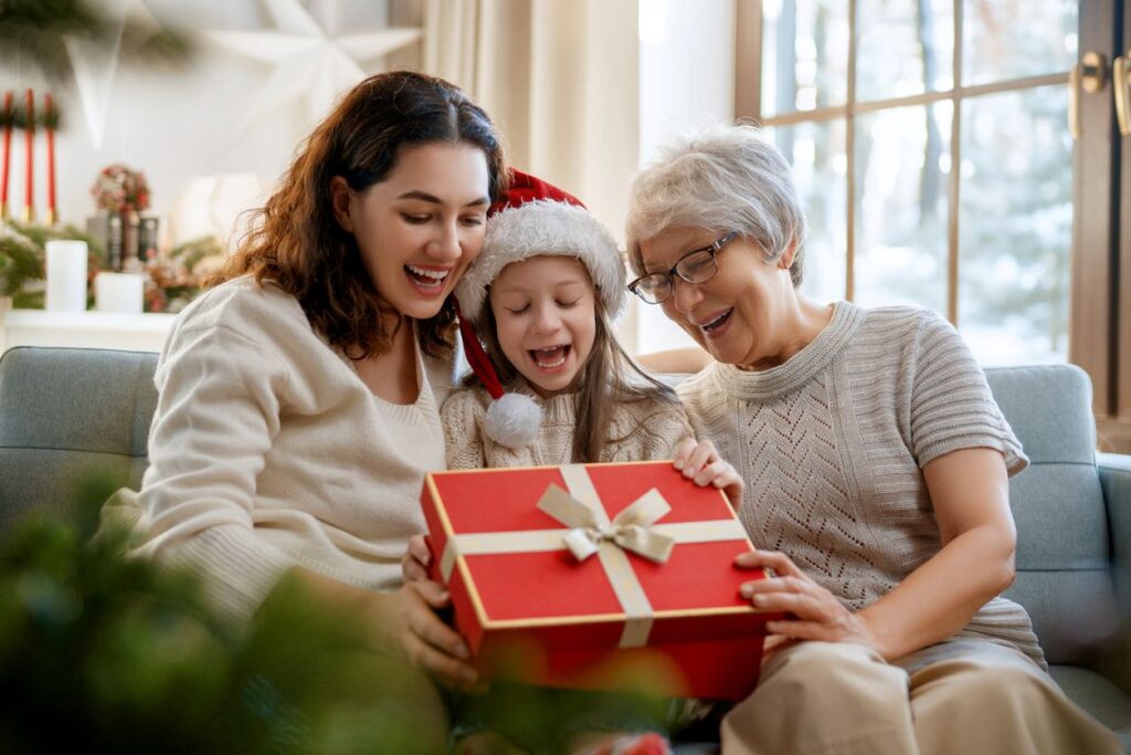 A family sitting down opening Christmas presents together.