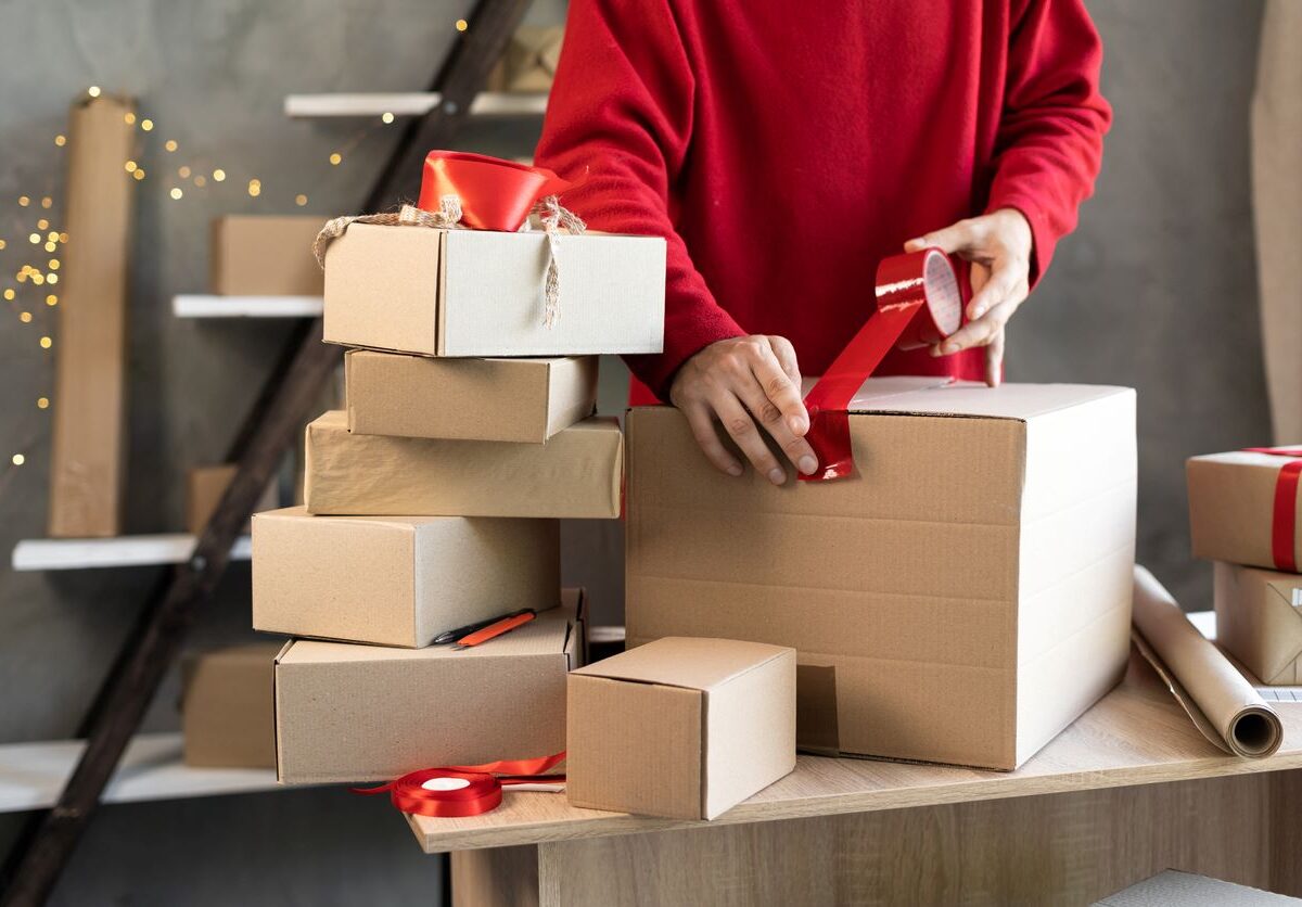 A person wrapping presents for the holiday season.