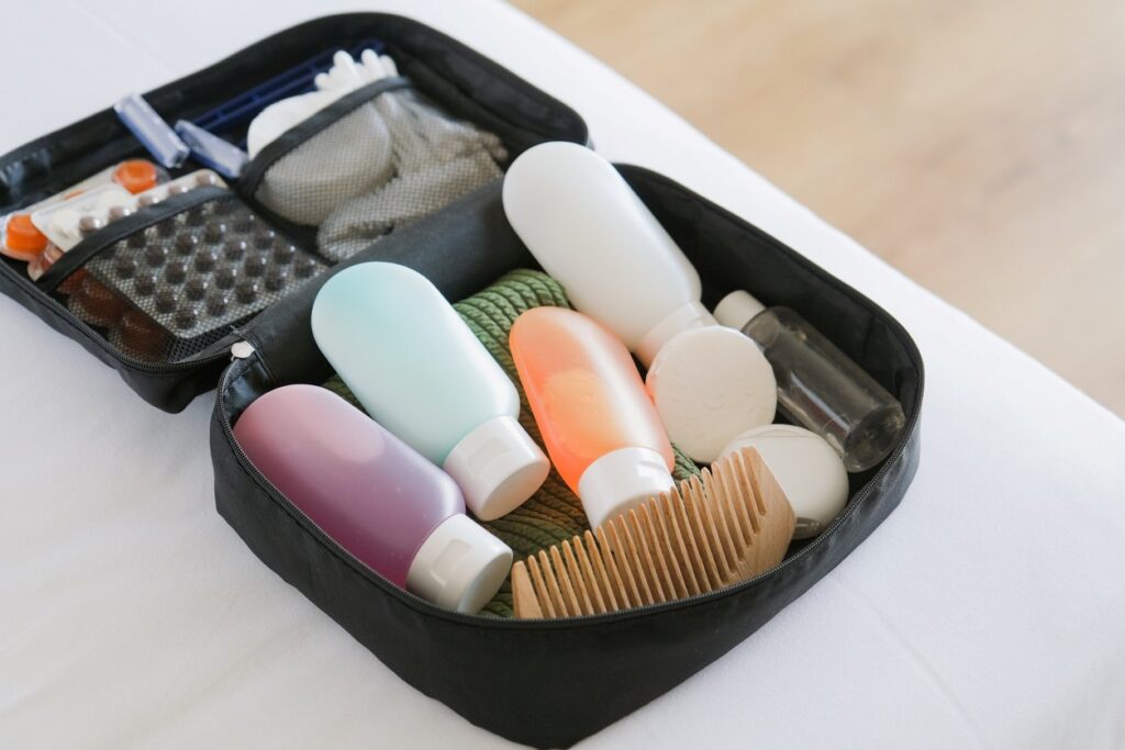 A small black travel bag full of essentials, like toiletries and medicine, for a move. 